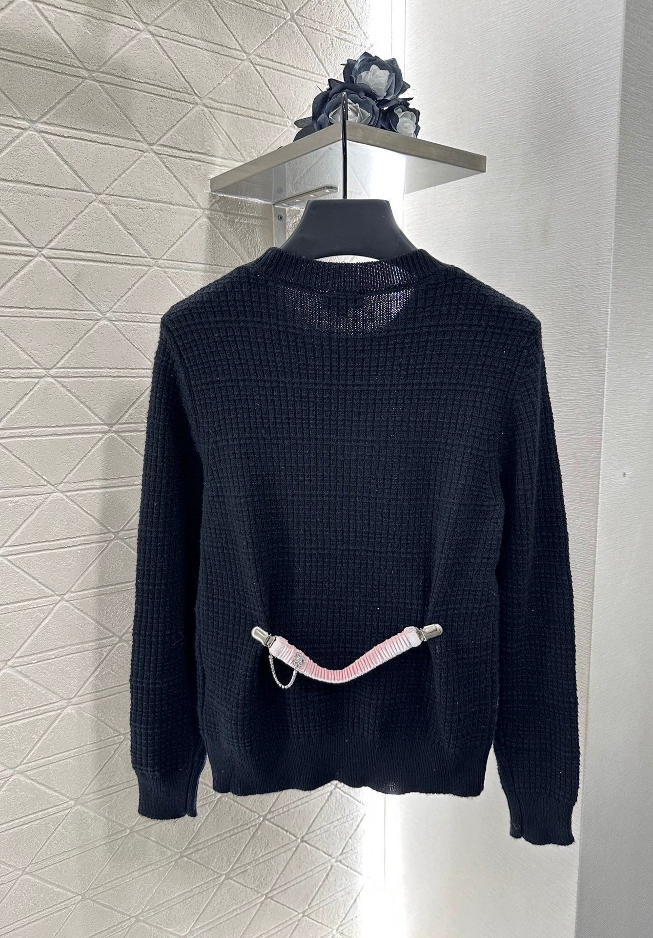 25 A simple logo sweater with a chain detail at the back waist.