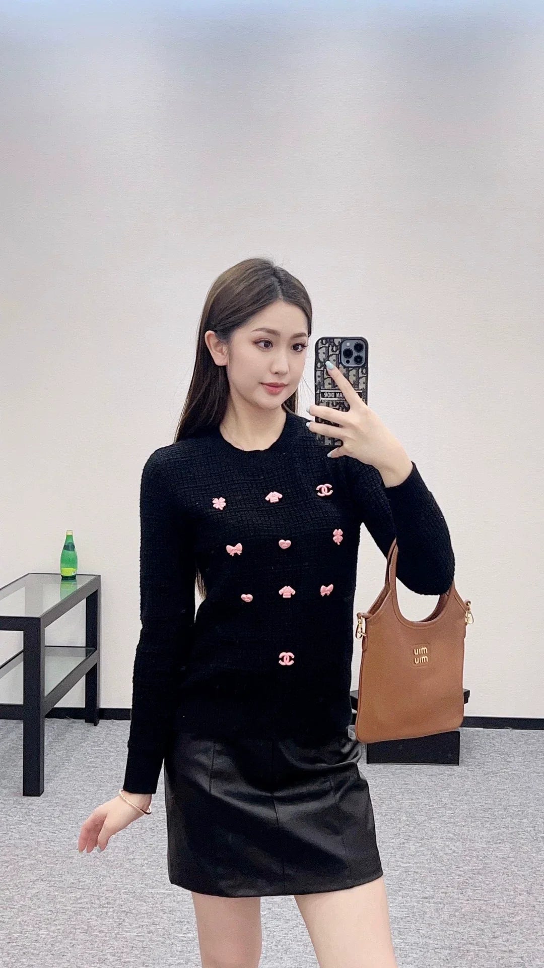 25 A simple logo sweater with a chain detail at the back waist.