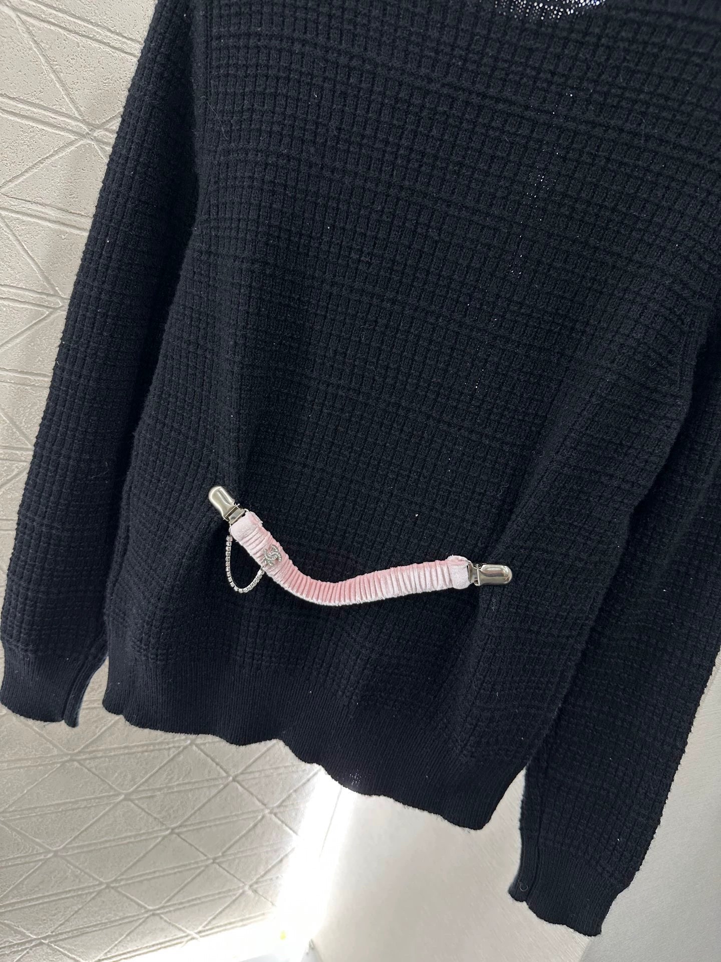 25 A simple logo sweater with a chain detail at the back waist.
